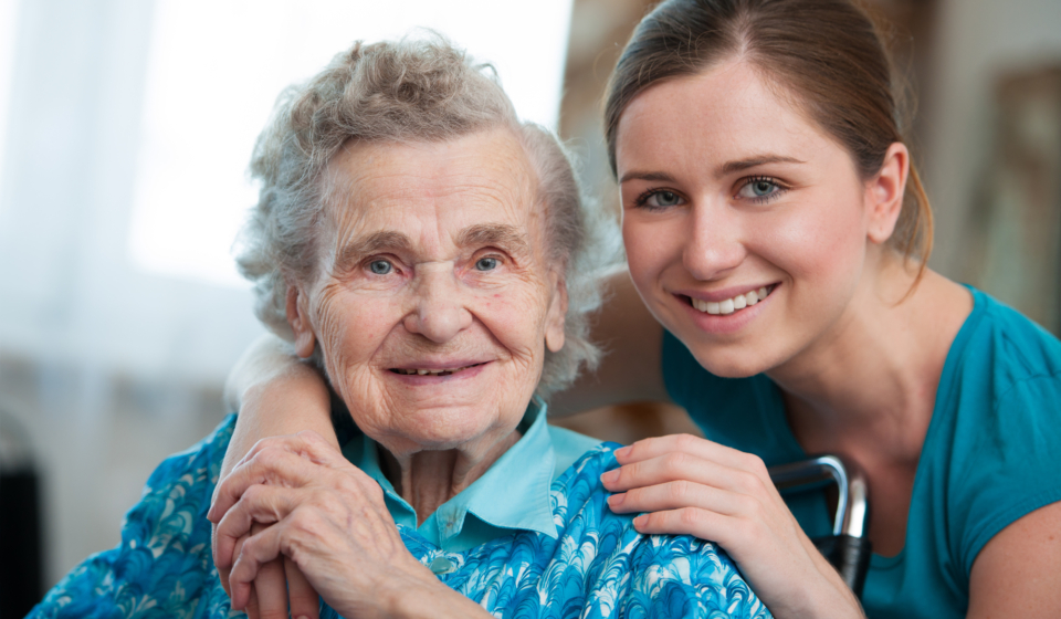 Senior woman with her caregiver at home